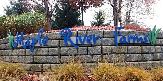 Farm entrance with blue lettering